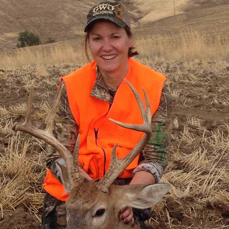 Woman smiling and displaying her deer